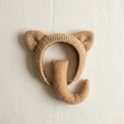 A soft knit animal-ear headband and a short felt tail